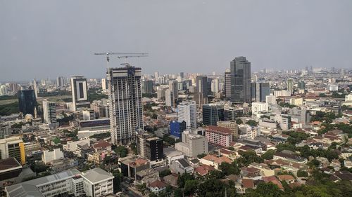 High angle view of modern buildings in city against sky