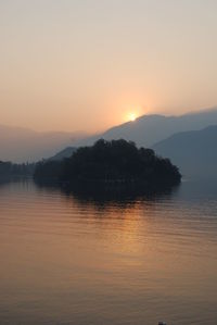 Scenic view of lake against sky during sunset