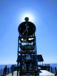 Low angle view of tower against blue sky