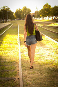 Rear view of woman walking in park