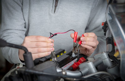 Close-up of man working on cable car