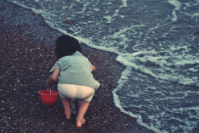 Rear view of woman standing on beach