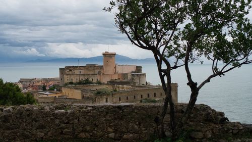 View of old building against cloudy sky