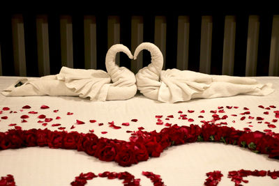 Heart shape made of white flower on bed