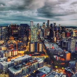 High angle view of illuminated city buildings against sky