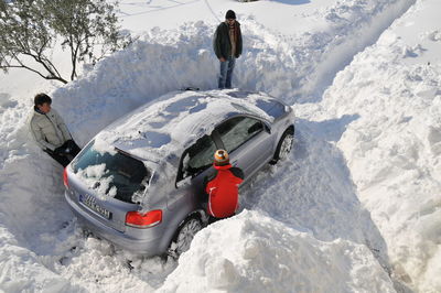 Rear view of people in snow