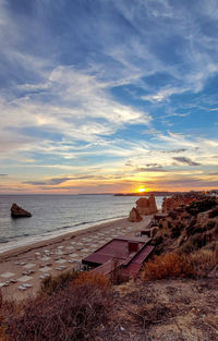 Scenic view of beach against sky during sunset