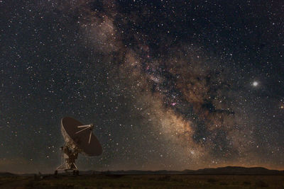 Windmill against sky at night