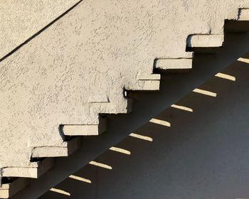 Low angle view of staircase against wall