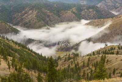 Sunrise in the mountains with clouds in the valley