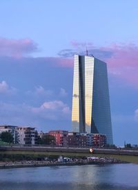 View of modern building against cloudy sky