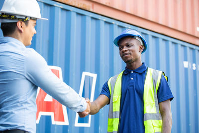 Young man working with arms raised