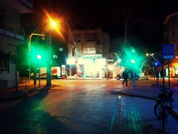 Illuminated city street at night