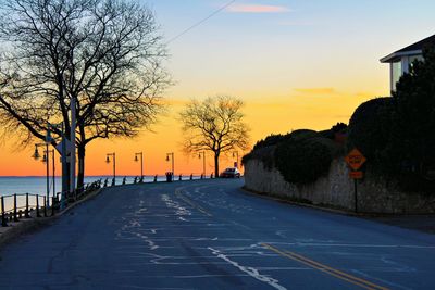 Empty road against sky during sunset