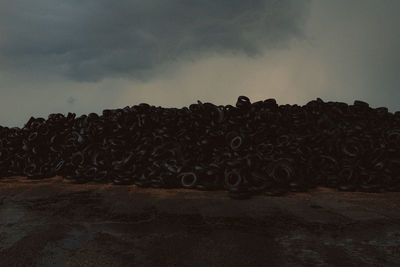 Low angle view of stack on road against sky