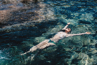 High angle view of woman swimming underwater