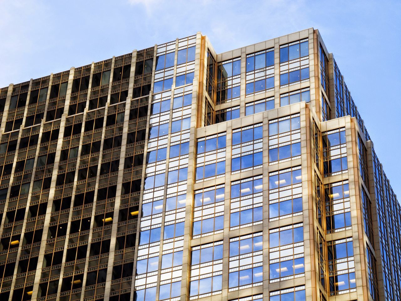 architecture, building exterior, low angle view, built structure, modern, glass - material, office building, window, city, building, tall - high, reflection, skyscraper, clear sky, sky, tower, day, no people, glass, outdoors