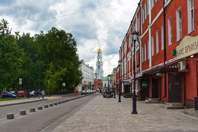 Street amidst buildings in city against sky