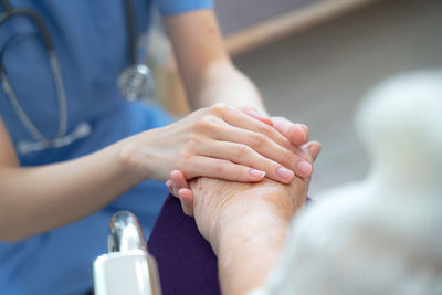 Midsection of doctor examining patient in hospital