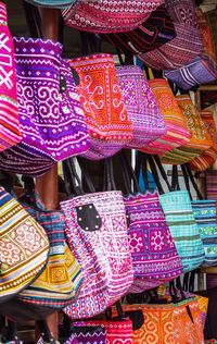 Close-up of colorful bags for sale at market