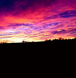 Silhouette landscape against sky at sunset