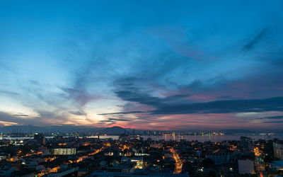 High angle view of illuminated city against sky at sunset