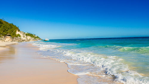 Scenic view of sea against clear blue sky