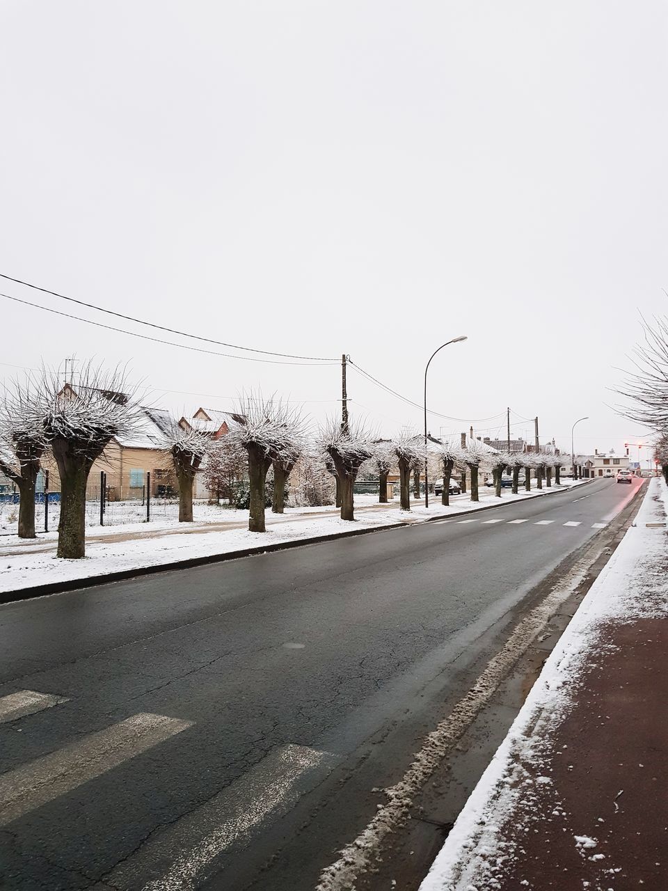 STREET BY SNOW AGAINST CLEAR SKY