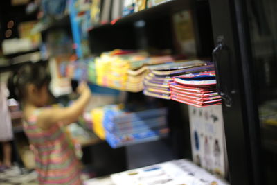 Defocused image of girl standing in bookstore