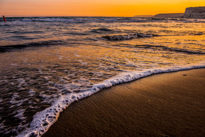 Scenic view of beach against sky during sunset