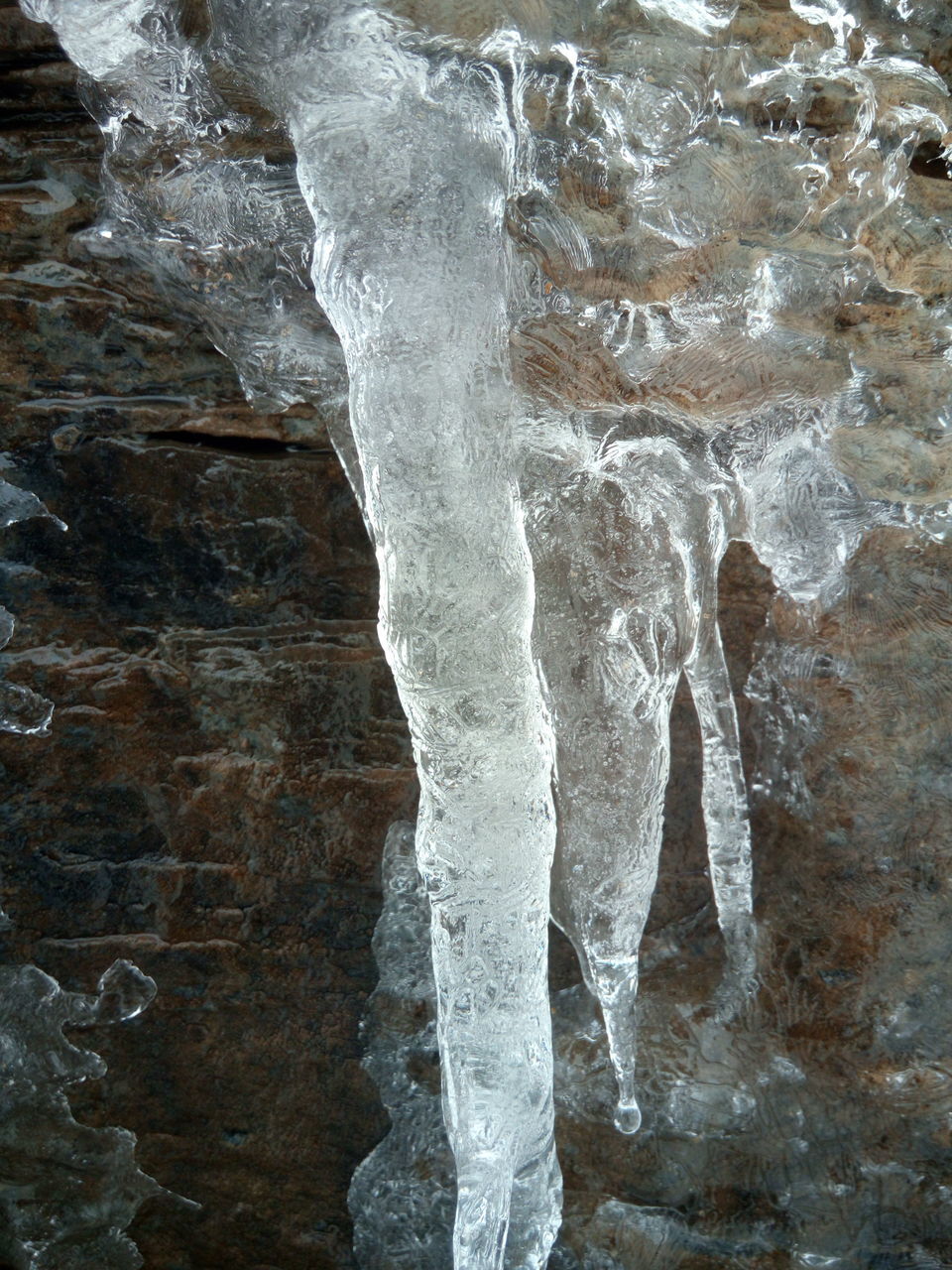 CLOSE-UP OF ICE CRYSTALS ON ROCK