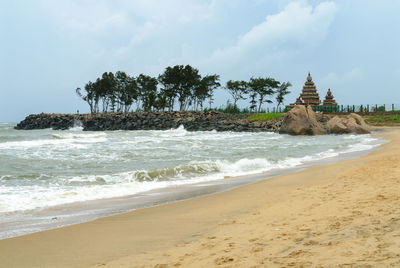 View of beach against cloudy sky