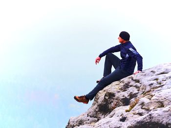 Full length of man on rock against sky