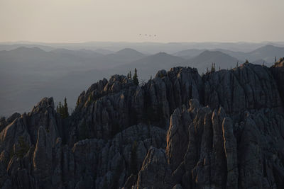 Panoramic view of rocky mountains in custer state park at sunset with 4 black hawk helicopters