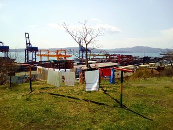 Clothes drying on landscape against sky