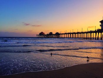 Huntington beach pier over sea during sunset