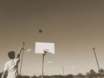 Low angle view of silhouette man against sky