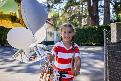 Portrait of smiling young woman holding umbrella
