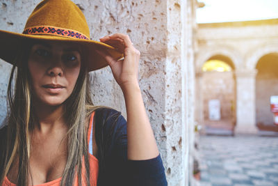 Portrait of young woman wearing hat