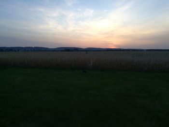 Scenic view of field against sky during sunset