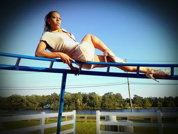 Low angle view of woman against blue sky