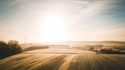 Scenic view of field against sky during sunset