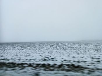 Scenic view of sea against clear sky during winter