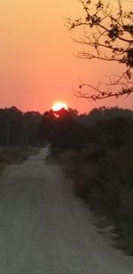 Scenic view of landscape against orange sky