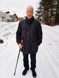 Portrait of man standing on snow