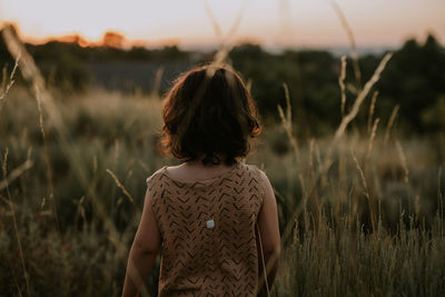 Rear view child standing in the fields