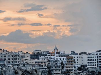 Cityscape against sky during sunset