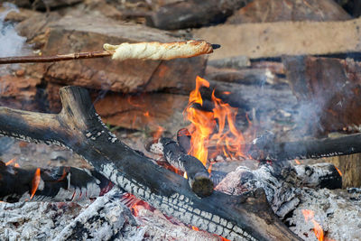 Close-up of bonfire on log