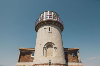 Low angle view of tower against blue sky