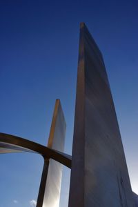 Low angle view of bridge against clear blue sky